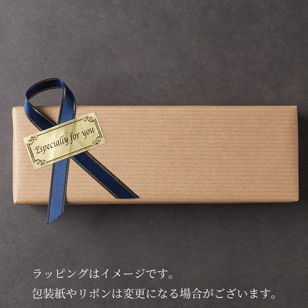 木軸ペンのギフトラッピング。男女問わず喜ばれる紺色のリボンに金色のシール。薄茶色のシンプルで上品なギフト包装。